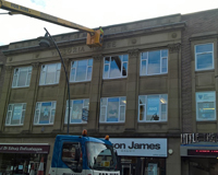 Worker using a Cherry Picker to work on the top of Victoria House
